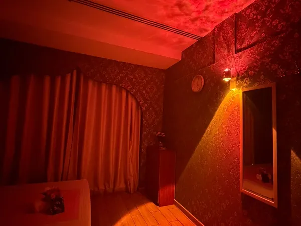 Massage room with mood lighting and full-length mirror at Opaline Spa Dubai
